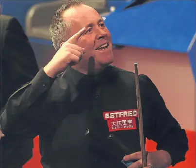  ?? Picture: PA. ?? John Higgins celebrates victory over Ryan Day and a place in the second round.