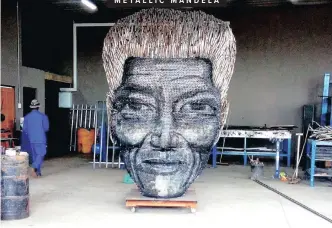  ??  ?? ARTIST Minenhle Nxele, below, created a 3D sculpture of Nelson Mandela’s face using about 12 000 pieces of scrap metal. It will be displayed as an upcycled art piece at Global Scrap Metal’s new branch in the Pietermari­tzburg city centre next month.