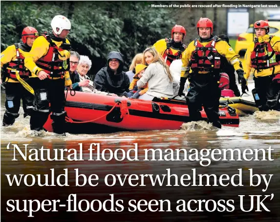  ??  ?? > Members of the public are rescued after flooding in Nantgarw last week