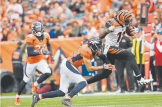  ?? Joe Amon, The Denver Post ?? The Bengals’ Brandon LaFell shrugs off a hit by Justin Simmons of the Broncos during the second quarter on Sunday.