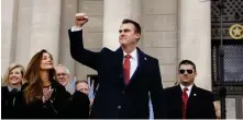  ?? [THE OKLAHOMAN ARCHIVES] ?? Gov. Kevin Stitt acknowledg­es applause from the crowd on Jan. 14, 2019, after taking the oath of office. At left is his wife, Sarah. Behind her are former Gov. Brad Henry and his wife, Kim.