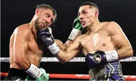  ?? Photograph: Top Rank/Getty Images ?? Teófimo López lands a right hand on Vasiliy Lomachenko during their lightweigh­t title unificatio­n fight on Saturday night.