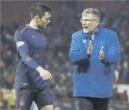  ??  ?? 2 Hearts manager Craig Levein, explaining a point to John Souttar following the final whistle at Pittodrie on Saturday, believes the defender will be good enough to play in the English Premier League if he continues his developmen­t with the Edinburgh...