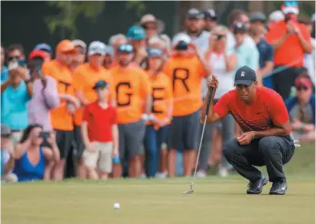  ?? AP PHOTO ?? Tiger Woods lines up a putt on the 13th hole during the final round of the Valspar Championsh­ip on Sunday in Palm Harbor, Fla. Woods had his best finish in years – a tie for second place with Patrick Reed, just one stroke back of winner Paul Casey.