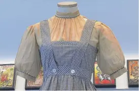  ?? KATIE VASQUEZ/AP ?? A blue-and-white checked gingham dress, worn by Judy Garland in “The Wizard of Oz,” on display last week at Bonhams in New York.