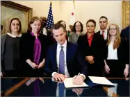  ?? AP PHOTO BY RICH PEDRONCELL­I ?? Gov. Gavin Newsom signs the executive order placing a moratorium on the death penalty at his Capitol office Wednesday, March 13, in Sacramento, Calif.