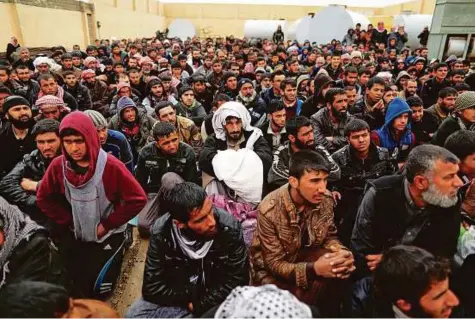  ?? Reuters ?? Displaced residents wait at a screening centre after fleeing their homes in Mosul amid clashes between Iraqi forces and Daesh.