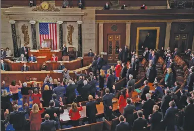  ?? (AP/Erin Scott) ?? House Speaker Nancy Pelosi administer­s the oath of office Sunday to members of the 117th Congress at the U.S. Capitol in Washington.