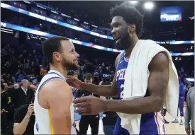  ?? JEFF CHIU — THE ASSOCIATED PRESS ?? Golden State Warriors guard Stephen Curry, left, talks with Philadelph­ia 76ers center Joel Embiid after the Warriors defeated the 76ers in an NBA basketball game in San Francisco on Friday night.