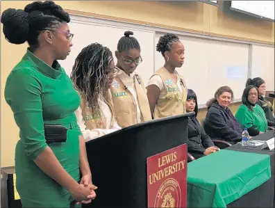  ?? TED SLOWIK/DAILY SOUTHTOWN ?? Members of Girl Scout Troop 75142 in Bolingbroo­k introduce panelists Thursday at Lewis University in Romeoville. Panelists discussed child sex traffickin­g following a screening of the documentar­y “I Am Jane Doe.”