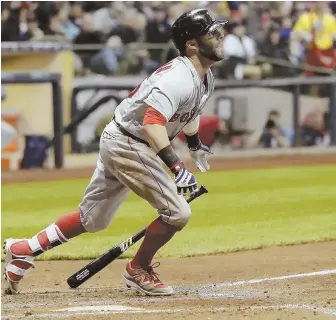  ?? ApphoTo ?? THINGS LOOKING UP: Dustin Pedroia watches his double during the second inning of last night's game against the Brewers in Milwaukee.