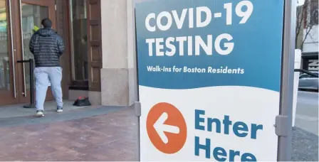  ?? BOsTON hErald FilE ?? ‘WORSENING WAVE’: A person enters the Bruce Bolling Building in Nubian Square at the COVID-19 test site on Jan. 22, 2022 in Boston.