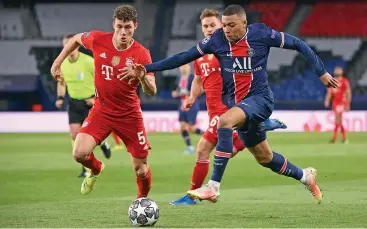  ?? (AFP) ?? PSG's Kylian Mbappe (R) fights for the ball with Bayern Munich's Benjamin Pavard at the Parc des Princes stadium in Paris, France, on Tuesday