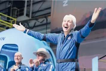  ?? TONY GUTIERREZ/AP ?? Mark Bezos, from left, and Amazon and Blue Origin founder Jeff Bezos applaud as Wally Funk describes their experience aboard the New Shepard rocket after they returned Tuesday to the spaceport near Van Horn, Texas.