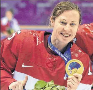  ?? CP PHOTO ?? Team Canada’s Jayna Hefford shows off her gold medal after defeating Team USA in the women’s gold medal game at the Sochi Winter Olympics in Sochi, Russia, on Feb. 21, 2014.