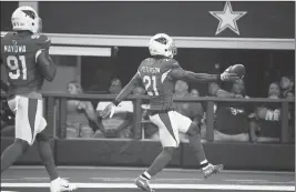  ?? ASSOCIATED PRESS ?? ARIZONA CARDINALS DEFENSIVE BACK PATRICK PETERSON (21) runs into the end zone with a touchdown followed by teammate Benson Mayowa (91) after an intercepti­on during the first half of a preseason NFL game against the Dallas Cowboys in Arlington, Texas on Sunday.