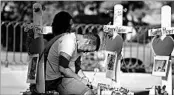  ?? ROBYN BECK/GETTY-AFP ?? Ethan Avanzino grieves beside a cross for friend Cameron Robinson, one of the victims of the Las Vegas shooting.