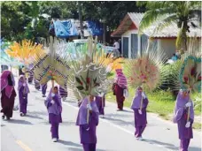  ?? — AFP ?? Schoolchil­dren parade during the opening ceremony of the Tadika Samphan festival, a local celebratio­n for children, in the Bacho district of Narathiwat province, Thailand, on Saturday.