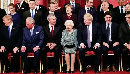  ??  ?? The Queen sits next to Boris Johnson at the reception for Nato leaders she hosted at Buckingham Palace last night