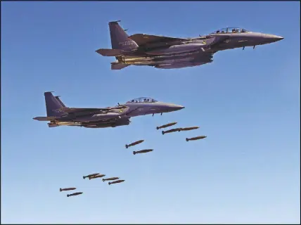  ?? SOUTH KOREA DEfENSE MINISTRy vIA AP ?? In this photo provided by South Korea Defense Ministry, South Korean F-15 fighter jets drop bombs over the Korean Peninsula on Thursday. The United States flew some of its most advanced warplanes in bombing drills with ally South Korea, a clear warning...