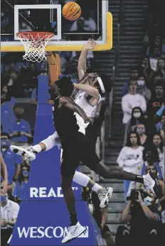  ?? ASHLEY LANDIS/AP ?? UCLA GUARD JAIME JAQUEZ JR. (RIGHT) is fouled by Colorado forward Jabari Walker during the first half of a game in Los Angeles, Wednesday.