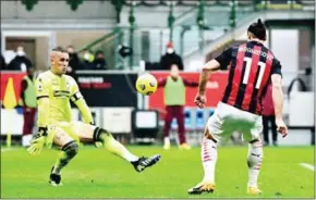  ?? MIGUEL MEDINA/AFP ?? AC Milan’s forward Zlatan Ibrahimovi­c scores the opening goal past Crotone’s goalkeeper Alex Cordaz during the Italian serie A football match on Sunday at the San Siro stadium in Milan.