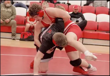  ?? Photo credit: Tom Hendrixson ?? Wapak’s Andrew Mosler works to flip his Kenton opponent onto his back.
The senior 215 pounder’s effort paid off with a pin in the third period during Thursday nights dual meet.