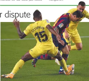  ?? Photo: Nampa/AFP ?? Back with a bang… Villarreal’s midfielder Moises Gomez (right) and defender Pervis Estupinan (left) challenge Barcelona’s forward Lionel Messi.