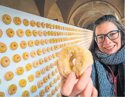  ?? Pictures: Kris Miller. ?? Chloe Milne with the Fisher and Donaldson doughnut wall which has establishe­d a new world record.