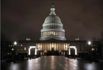  ?? J. SCOTT APPLEWHITE — THE ASSOCIATED PRESS ?? The Capitol is seen before dawn Wednesday after a night of negotiatin­g on the government spending bill, in Washington. Talks over a $1.3 trillion omnibus bill are almost complete as the White House and Capitol Hill Democrats ironed out deals on a first...