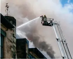  ??  ?? Below: The Glasgow School of Art burns in 2014, and under restoratio­n in 2017; a second fire caused extensive damage in 2018