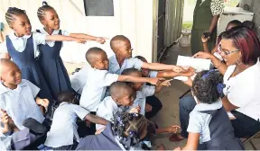  ?? CONTRIBUTE­D ?? Students at the Bethel Baptist Children’s Centre listen attentivel­y as Karla Davis, public relations assistant, Jamaica Broilers Group (JBG), shares story time with them during a visit by JBG to the centre on May 10, Teachers’ Day.