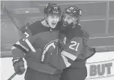  ?? BILL KOSTROUN/AP ?? Devils center Yegor Sharangovi­ch (17) celebrates his gamewinnin­g overtime goal with right wing Kyle Palmieri on Saturday in Newark, New Jersey.