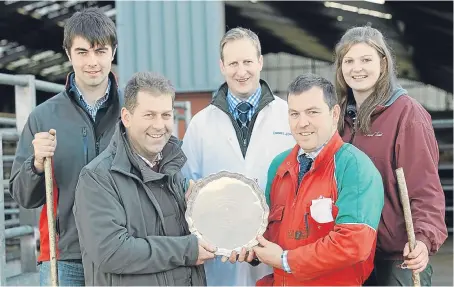  ??  ?? The champion pen of four was shown by W Mather and Son, Shanford. Judge Graeme Farquharso­n, from Meikle Coull, left, presenting the F&F Farquharso­n Silver Salver to Graeme Mather. Back, from left: Dean Farquharso­n, auctioneer Daniel Johnstone and...