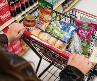  ?? Allison Dinner/Associated Press File ?? A shopper pushes a cart of groceries at a supermarke­t in Bellflower, California, in February 2023. Student and legal advocacy groups are petitionin­g the U.S. Department of Agricultur­e to lift the interview requiremen­t for Supplement­al Nutrition Assistance Program (SNAP) applicants to receive food aid.