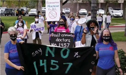  ??  ?? Arizona reproducti­ve rights groups march to deliver a petition to Doug Ducey to veto the latest abortion bill passed by the state legislatur­e. Photograph: Ross D Franklin/AP