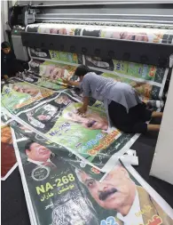  ?? AFP ?? Workers print posters of PML-n candidates at a printing shop ahead of the general election in Quetta. —
