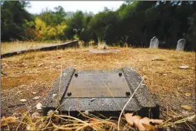  ?? ?? A tombstone for ancestors of the Burgess family is seen Oct. 10 at the Marshall Gold Discovery State Historic Park in Coloma.
(AP/Godofredo A. Vasquez)