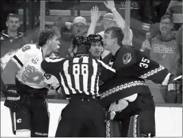  ?? ASSOCIATED PRESS ?? LINESMAN TYSON BAKER (88) tries to break up Calgary Flames left wing Matthew Tkachuk (left) and Arizona Coyotes goaltender Darcy Kuemper (35) during a brawl during the second period of Saturday’s game in Glendale.