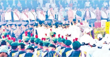  ??  ?? Tun Juhar takes the salute from the guard of honour during the ceremonial parade marking the Head of State’s 65th official birthday yesterday.