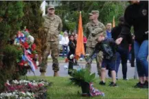  ?? LEAH MCDONALD - ONEIDA DAILY DISPATCH ?? Residents leave remembranc­e flowers in front of the veterans memorial in Triangle Park during the city of Oneida’s annual Memorial Day ceremony on Friday, May 24, 2019.