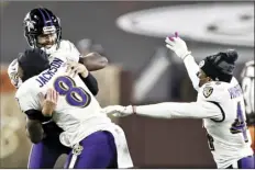  ?? AP photos ?? PHOTO ABOVE: Ravens quarterbac­k Lamar Jackson hugs kicker Justin Tucker after Tucker made the go-ahead field goal late in the fourth quarter Monday. PHOTO BELOW: Browns quarterbac­k Baker Mayfield throws a pass.