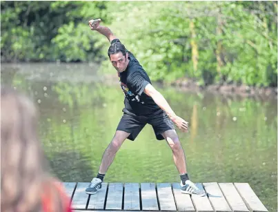  ??  ?? Champion stone skimmer Dougie Isaacs demonstrat­es his record-breaking technique.