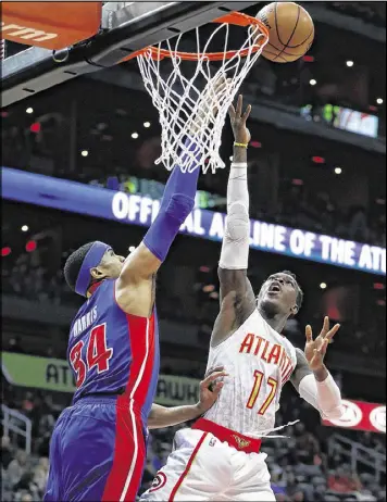  ?? JOHN BAZEMORE / AP ?? Dennis Schroder (right) shoots over Detroit’s Tobias Harris. Schroder is the Hawks’ second-leading scorer but ranks ninth in the league in turnovers.