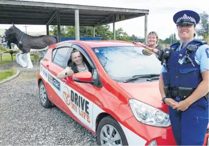  ?? PHOTO: RICHARD DAVISON ?? Skills to the test . . . South Otago Drive My Life student Briar Dawson (in car) picks up some lastminute driving test tips from project coordinato­rs Constable Rochelle Gordon and Clutha District Council road safety coordinato­r Rachel Harrison, in her hometown of Clinton.