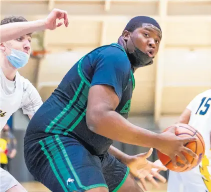  ?? VINCENT D. JOHNSON/DAILY SOUTHTOWN ?? Morgan Park’s Lidell Miller powers up against Glenbrook South’s Nick Martinelli during a game in Glenview on Dec. 22.