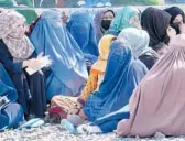  ?? EBRAHIM NOROOZI/AP ?? Afghan women dressed in head-to-toe clothing wait to receive food rations from a Saudi humanitari­an aid group April 25 in Kabul, Afghanista­n.