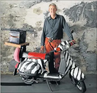  ?? Picture: FREDLIN ADRIAAN ?? ROAD AHEAD: Pierre Voges has a fondness for classic transport, including a brightly designed scooter, seen here at the Tramways Building