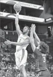  ?? Mary Altaffer Associated Press ?? ALABAMA’S DONTA HALL shoots over Minnesota’s Jordan Murphy. Hall was ejected in second half.