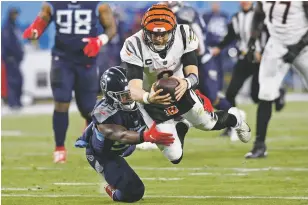  ?? MARK ZALESKI/ASSOCIATED PRESS FILE PHOTO ?? Bengals quarterbac­k Joe Burrow, above, leaps for a first down against Titans inside linebacker Jayon Brown during a NFC divisional round playoff game Jan. 22 in Nashville, Tenn.